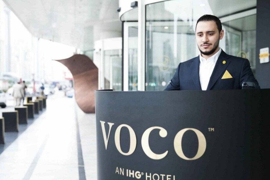 voco, an IHG Hotel front desk,hotel facade